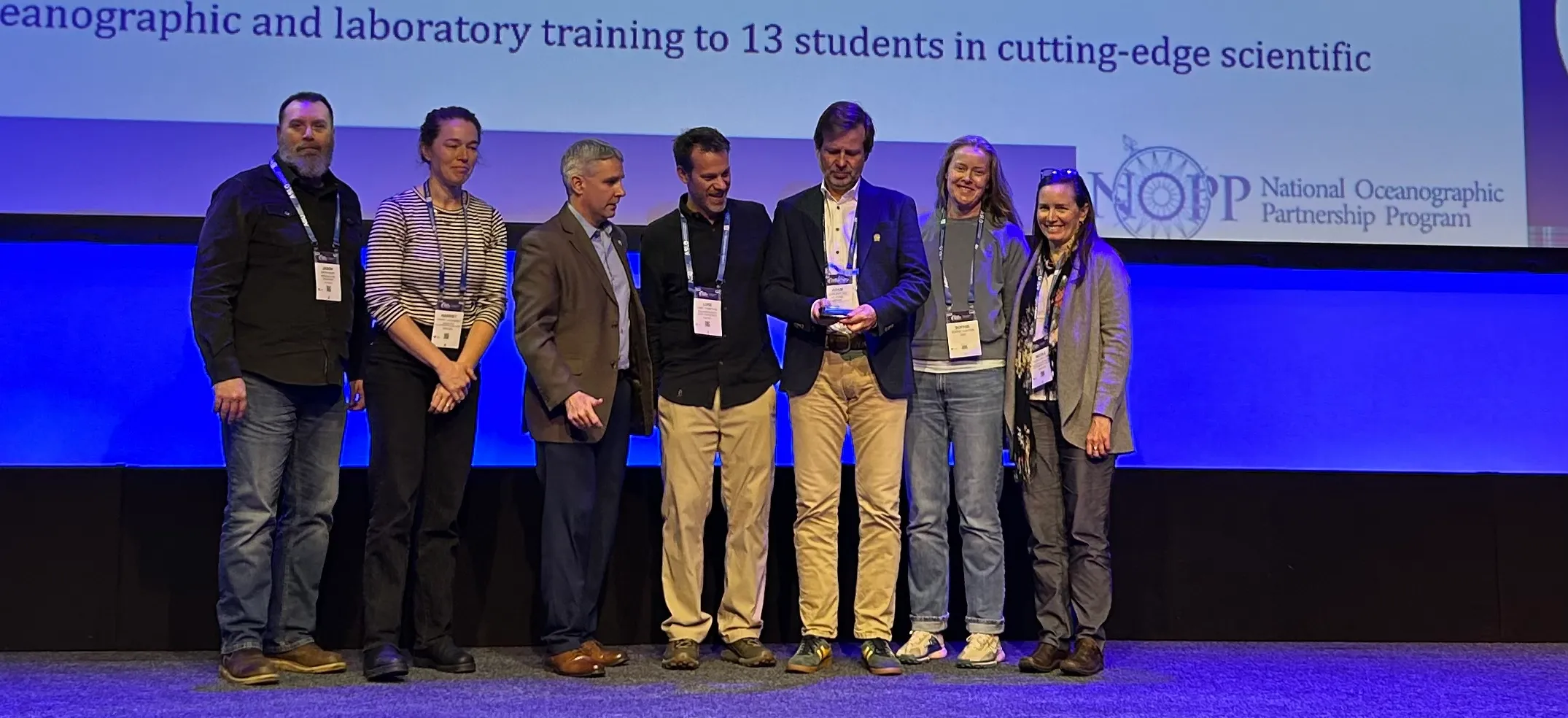 Bio-GO-SHIP team members on stage receiving the NOPP Excellence in Partnering Award at the 2026 Ocean Sciences Meeting in Glasgow